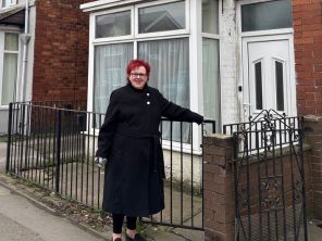 Cllr Sarah Allen stood outside of a terrace property.