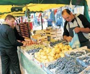 A person selling fruit at a market stall